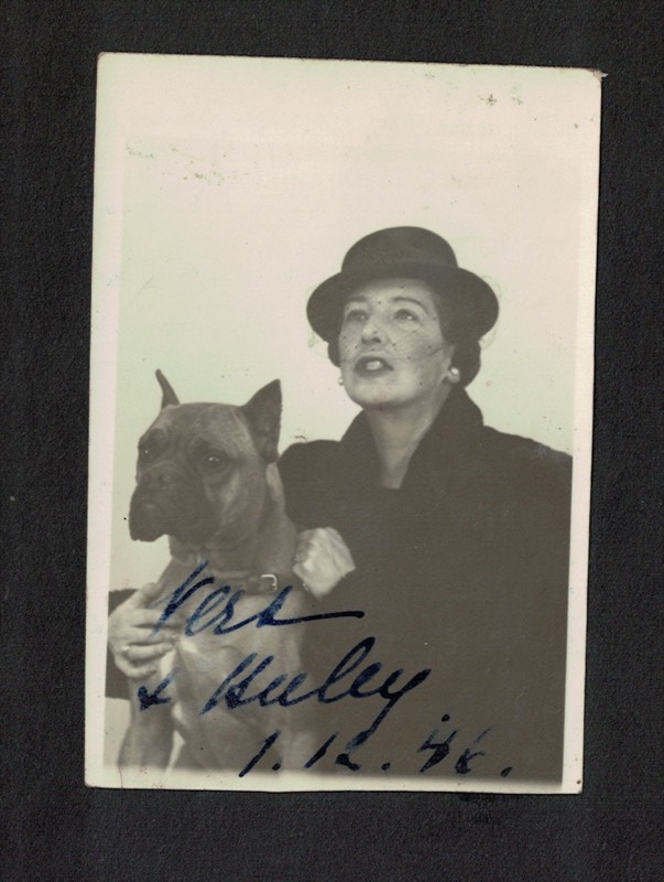 His mother in a veiled hat with her boxer, inscribed 1946