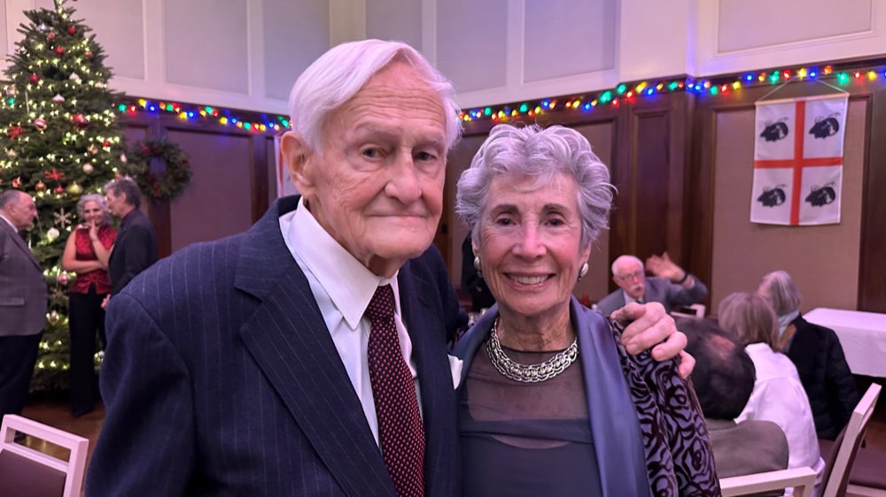 Alexander Kugushev with Barbara Olsen at a Christmas dinner